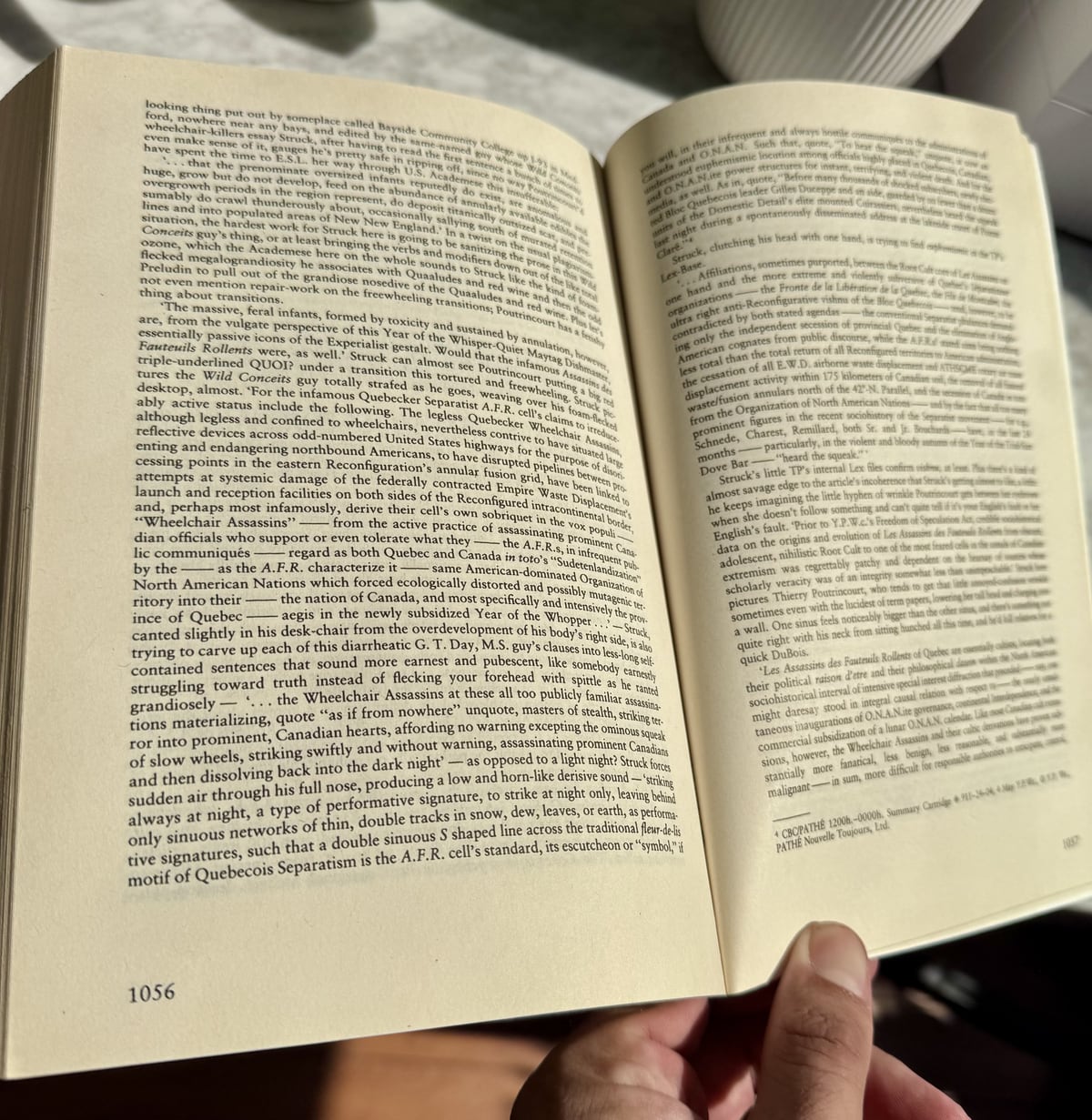 A copy of Infinite Jest open to two densely printed pages of its endnotes