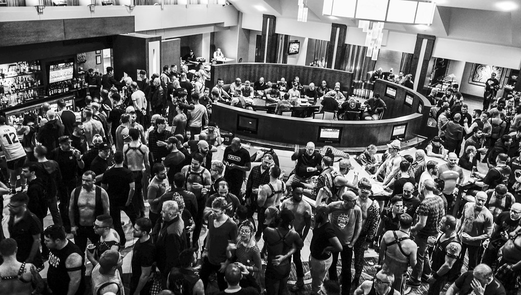 An overhead view of a large crowd gathered in the hotel lobby during Mid-Atlantic Leather Weekend in 2017.