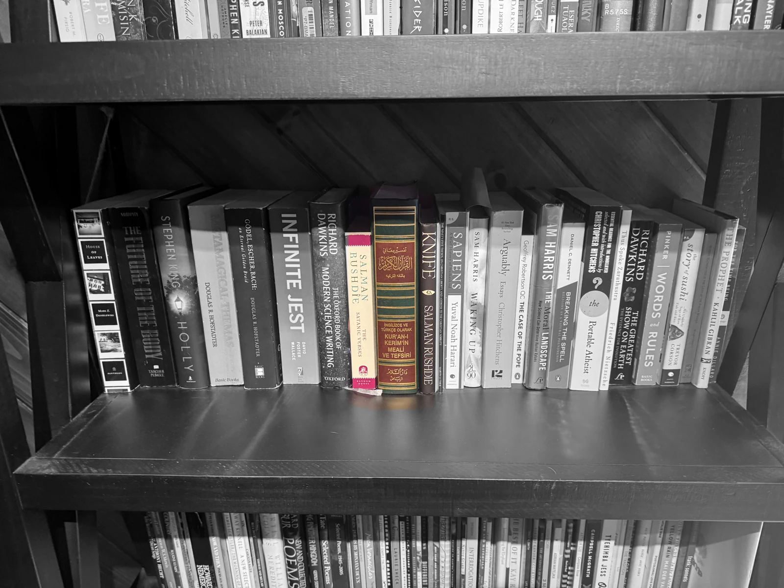 A black-and-white bookshelf with The Satanic Verses, the Quran, and Knife shown in color side by side.