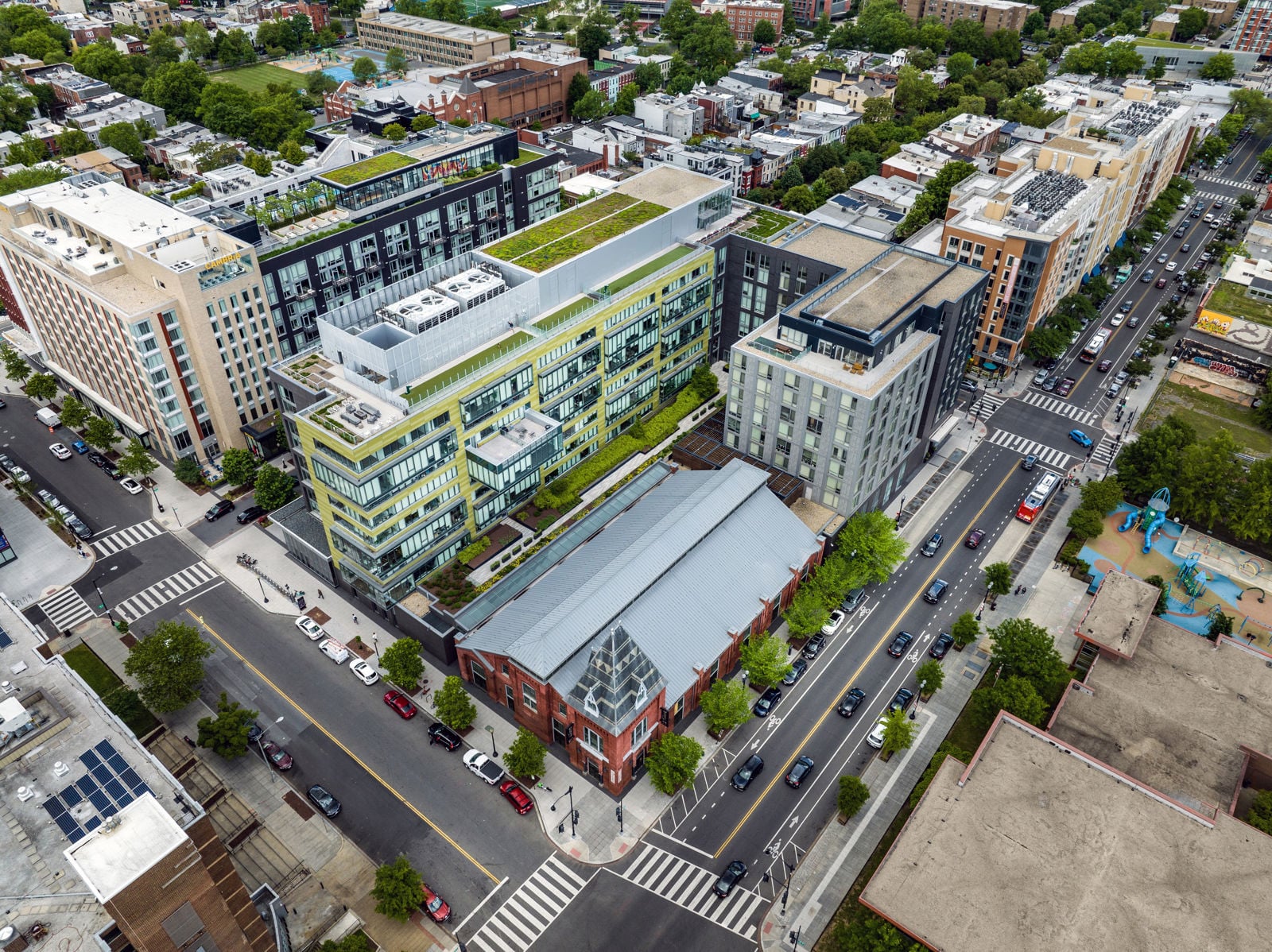Aerial view of the apartment complex, the Giant supermarket, and the landscaped terrace between the two buildings.