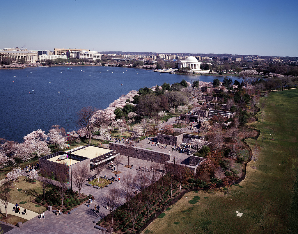 Aerial view of cherry blossoms around the Tidal Basin with the Jefferson Memorial in the distance.