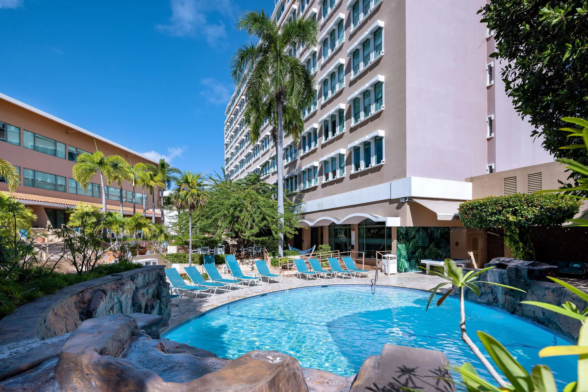 The pool and tropical courtyard at DoubleTree by Hilton San Juan.