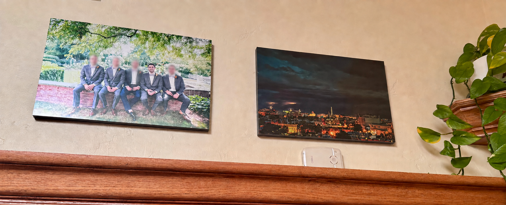 Two photographic prints hanging in the author's home: a wedding photograph on the left with four faces blurred, and a thunderstorm over Washington on the right.
