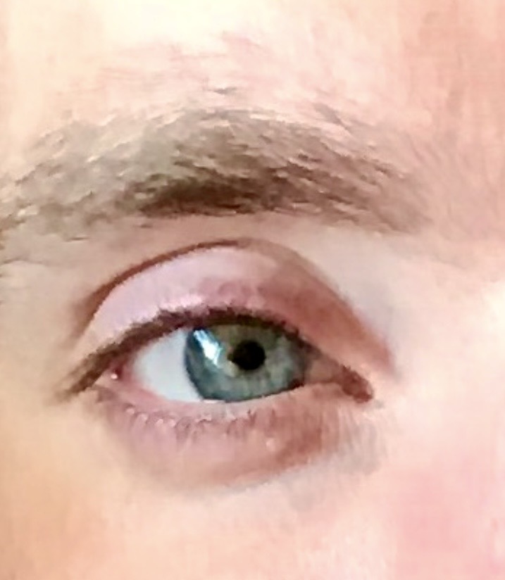 A close photograph of the blue eye that inspired the poem Your Eyes’ Blue.